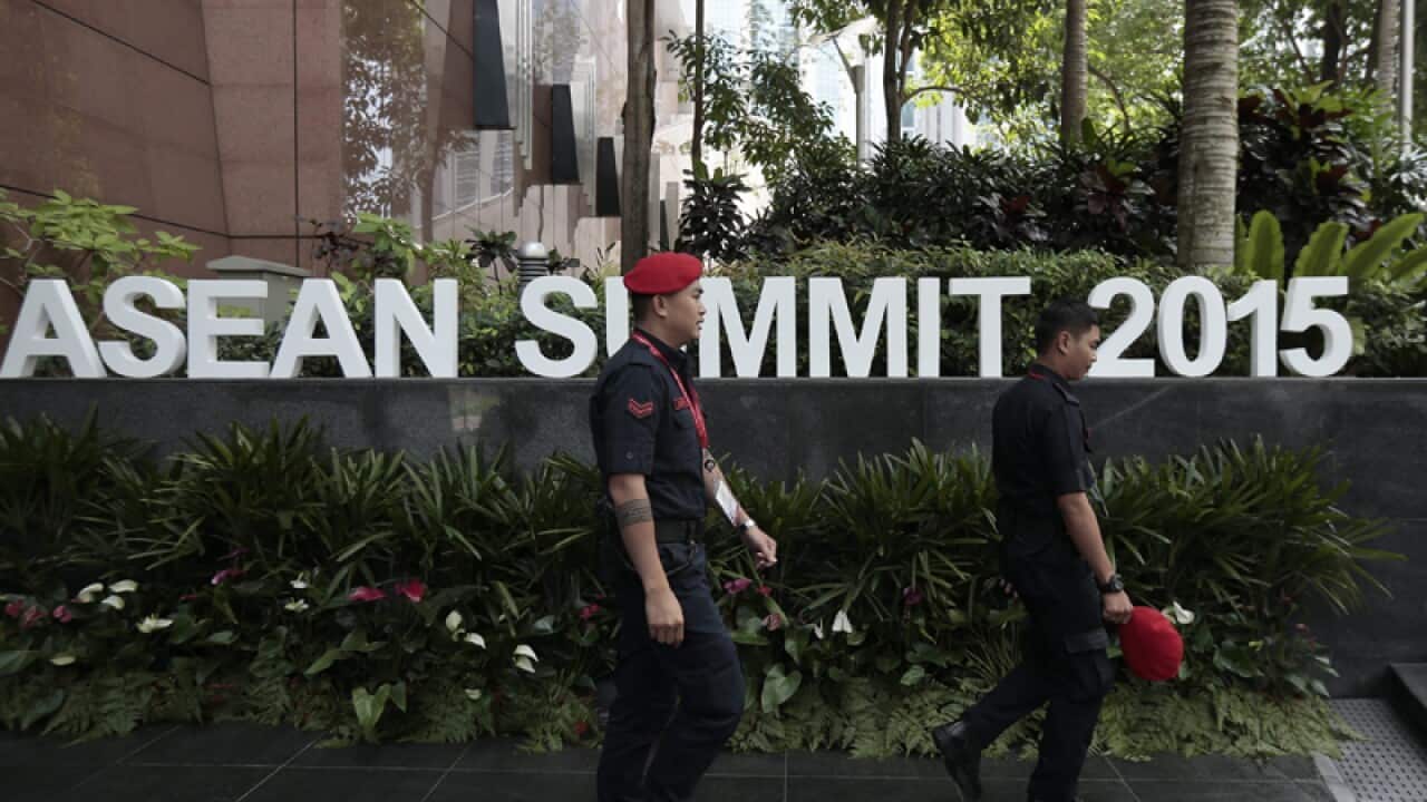 Security personnel walk past the Kuala Lumpur Convention Center