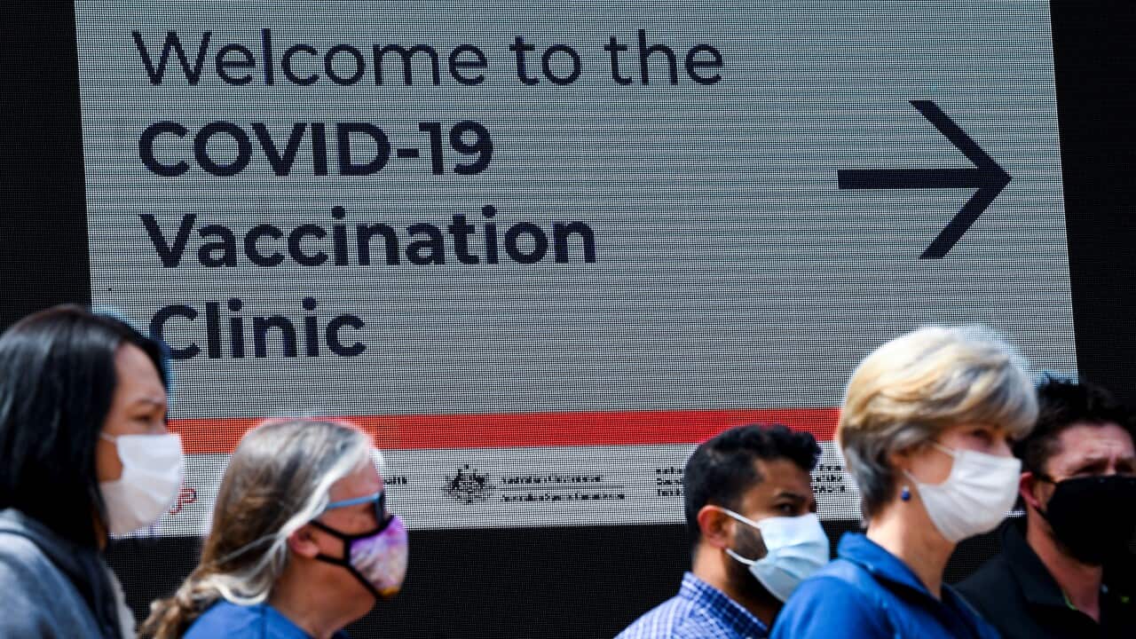 Residents at the COVID-19 vaccination clinic at the Australian Institute of Sport (AIS) in Canberra.