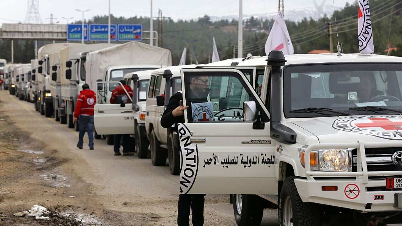 Aid vehicles wait on the outskirts of besieged rebel-held Syrian town of Madaya.