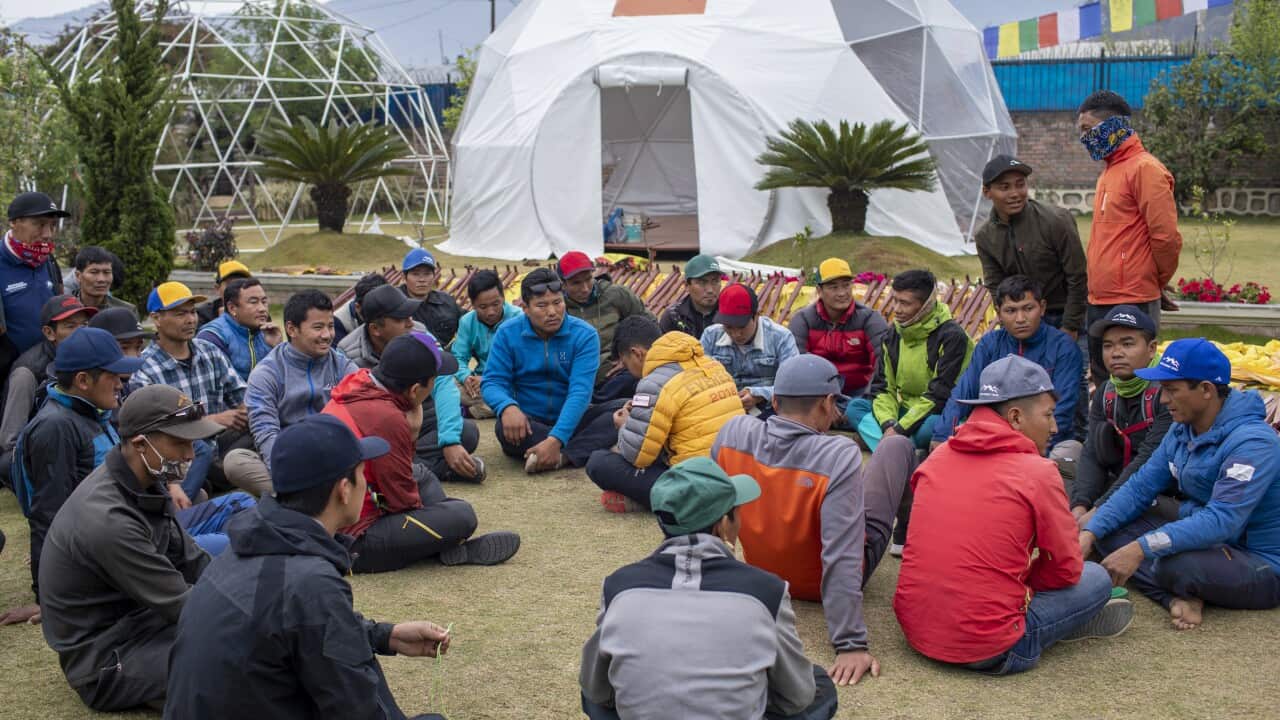 Nepalese Sherpas, who work as mountain guides, gather at the Seven Summit Trekking office