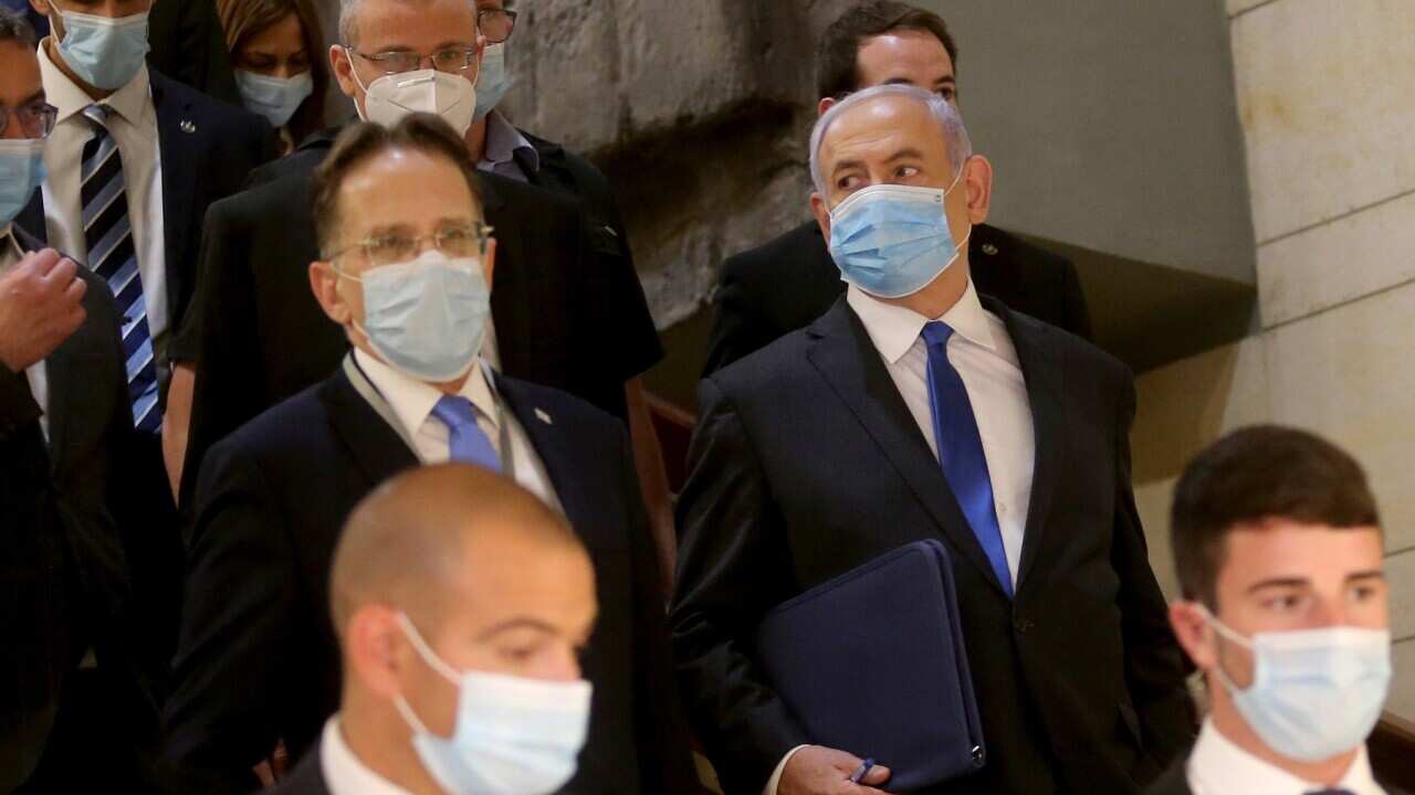 Benjamin Netanyahu wearing a protective face mask on his way to attend the swearing in ceremony of the Knesset