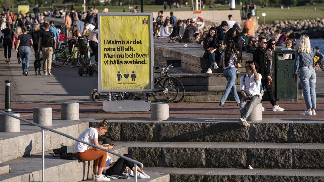People enjoy the warm evening weather in Malmo, Sweden