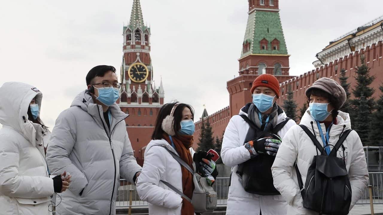 Tourists wear masks in Moscow's Red Square.
