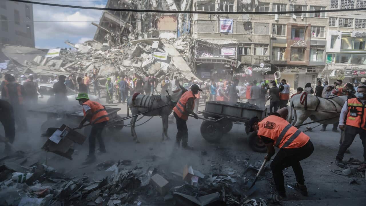 Palestinian volunteers clean up the streets of Gaza on Sunday, 23 May, 2021.