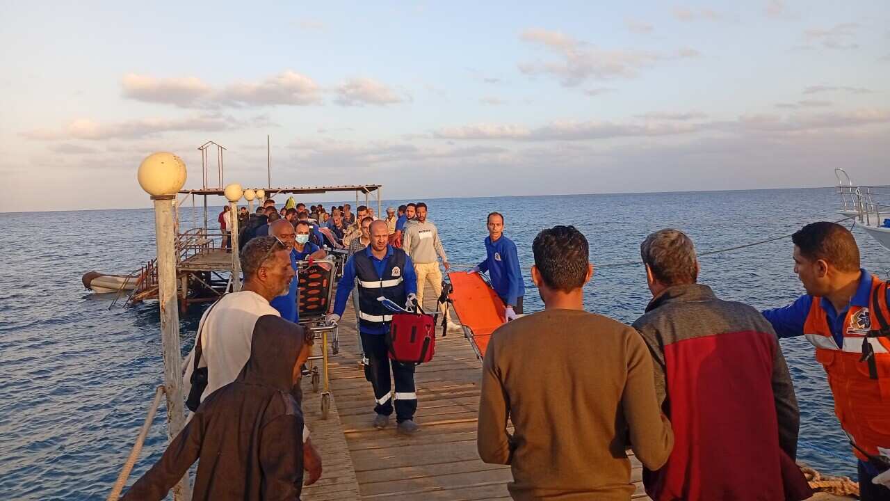 People and medical personnel on a jetty