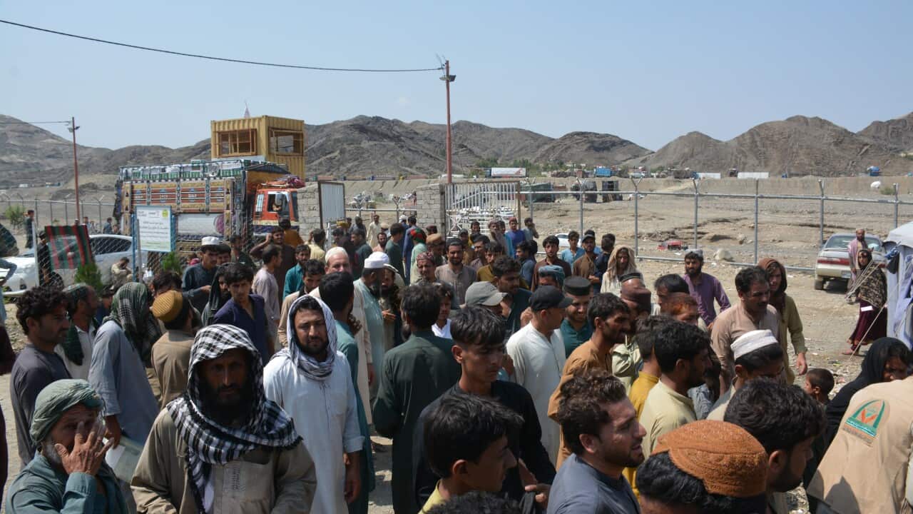 Arab charity provides food aid to refugees returning from neighboring Pakistan at Torkham