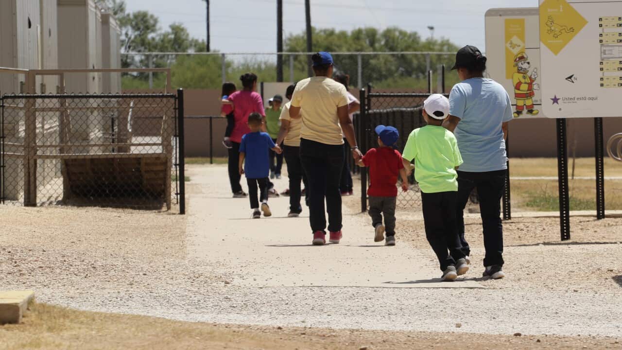 In this Aug. 23, 2019 file photo, immigrants leave a cafeteria at the ICE South Texas Family Residential Centre in Dilley, Texas