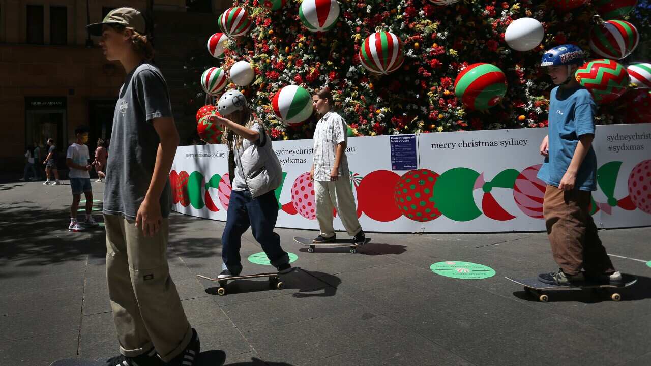 Children skate around a Christmas tree in Martin Place on December 17, 2021 in Sydney,