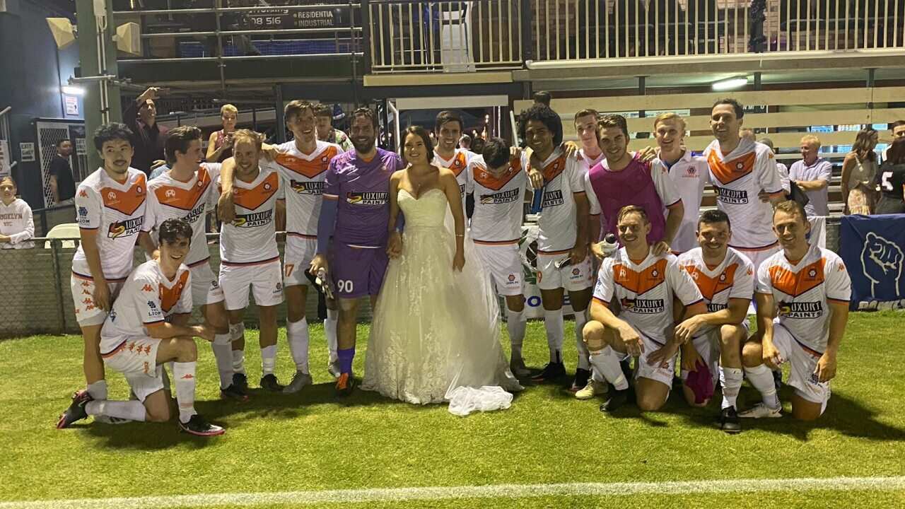 Luke Borean and his wife Ellen with the rest of the Lions FC squad