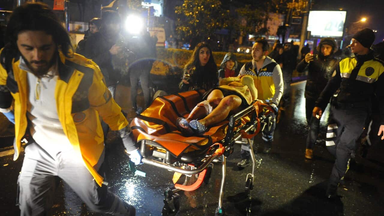 Medics carry a wounded victim on a stretcher to an ambulance after a gun attack on Reina, a popular night club in Istanbul
