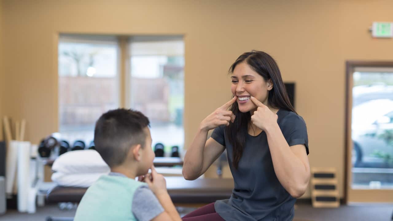 Speech therapist works with a young boy