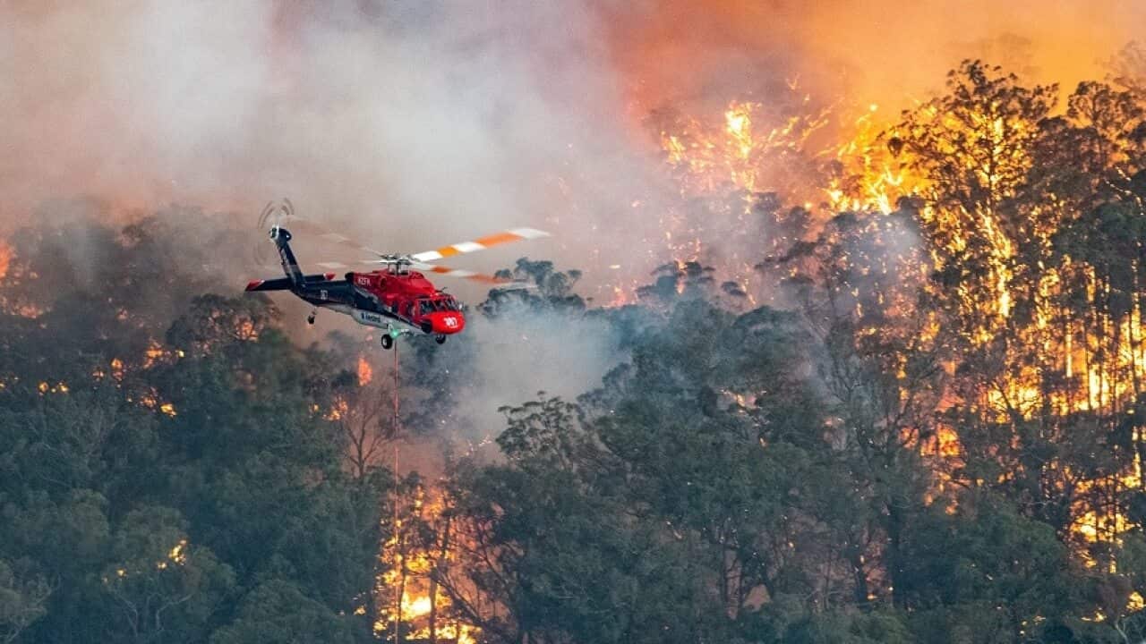 A supplied image obtained on Tuesday, December 31, 2019 showing a firefighting helicopter tackling a bushfire near Bairnsdale in Victoria?s East Gippsland region, Australia. Picture: (AAP IMAGE/State Government of Victoria) NO ARCHIVING