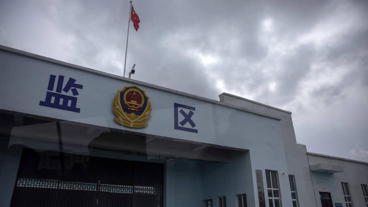 A Chinese national flag flies over a vehicle entrance to the inmate detention area at the Urumqi No. 3 Detention Center in Dabancheng in western China's Xinjiang Uyghur Autonomous Region, on April 23, 2021. (AP Photo/Mark Schiefelbein)