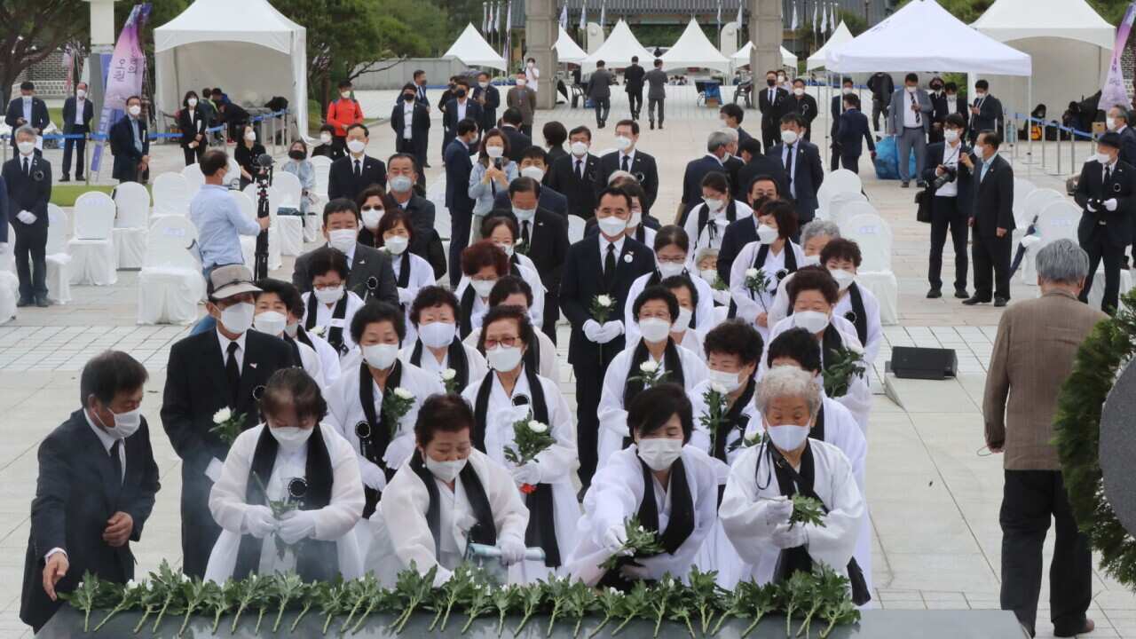 The bereaved family members of the victims of the 1980 pro-democracy movement lay flowers at the National Cemetery for the May 18th Democratic Uprising in Gwangju, South Korea, 17 May 2021, the eve of the incident's 41st anniversary.