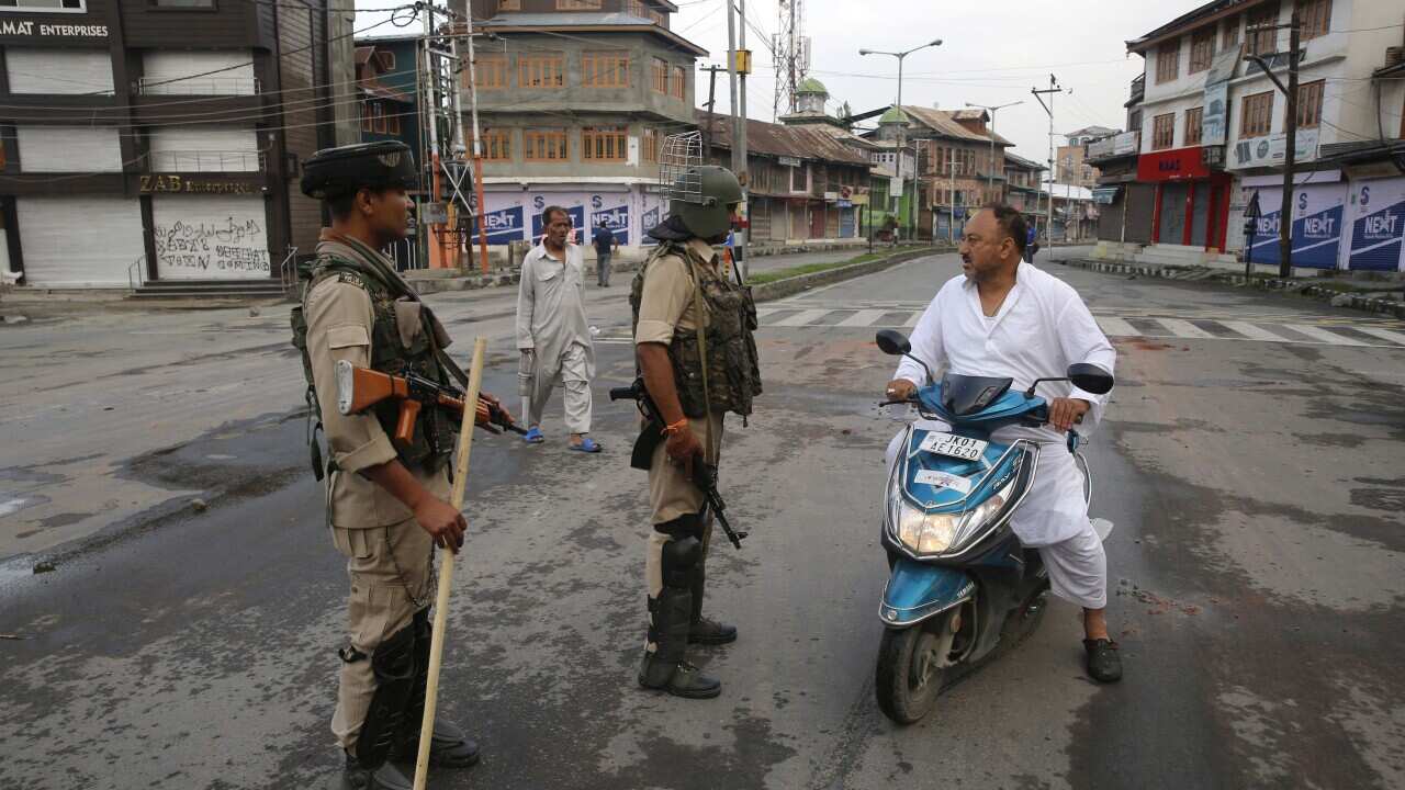 Indian paramilitary soldiers stop a Kashmiri man on a scooter during curfew in Srinagar, the summer capital of Indian Kashmir, 07 August 2019. EPA/FAROOQ KHAN