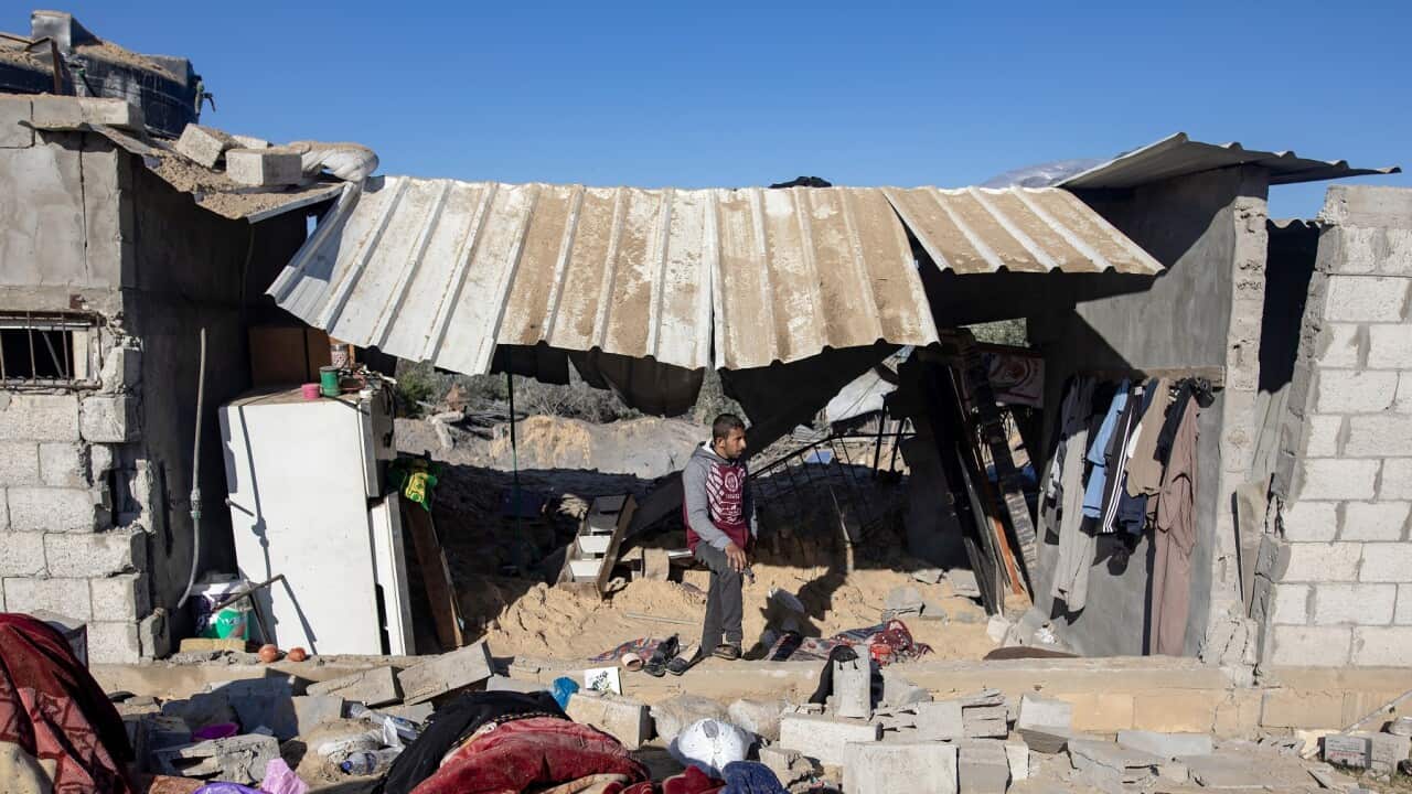 Palestinians inspect the rubble after an Israeli air strike in the southern Gaza Strip (AAP)