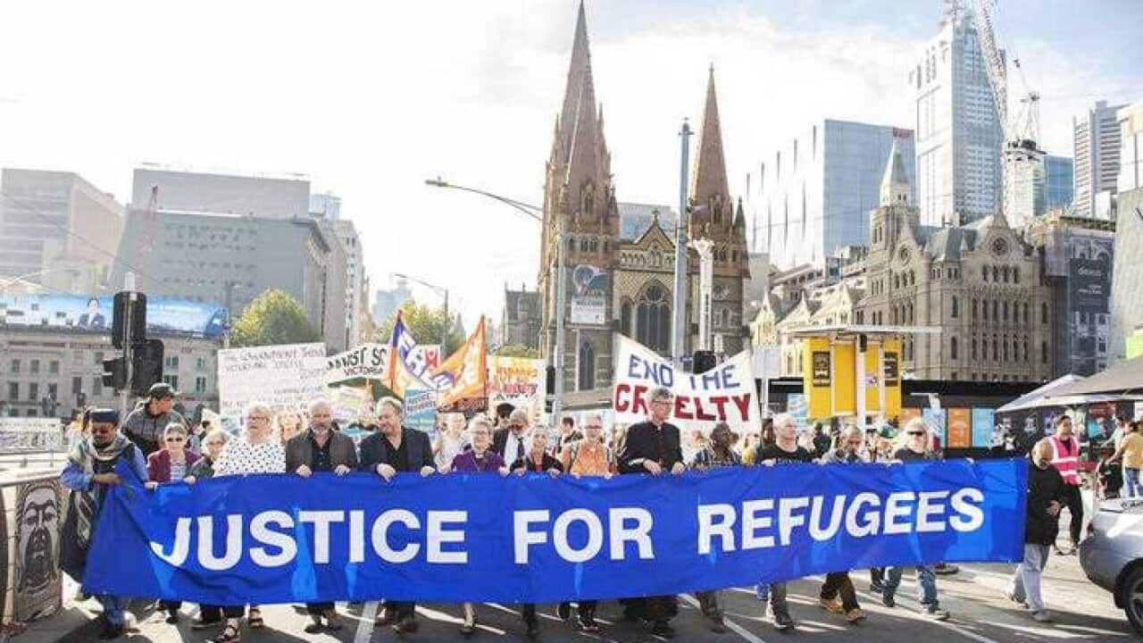 Refugee advocates at a Palm Sunday Rally outside the State Library in Melbourne