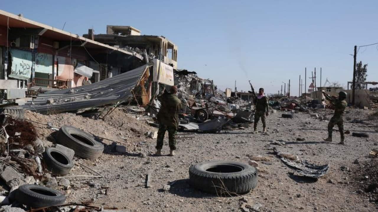 Kurdish peshmerga fighters fire into the the air while celebrating the retaking of of Sinjar.
