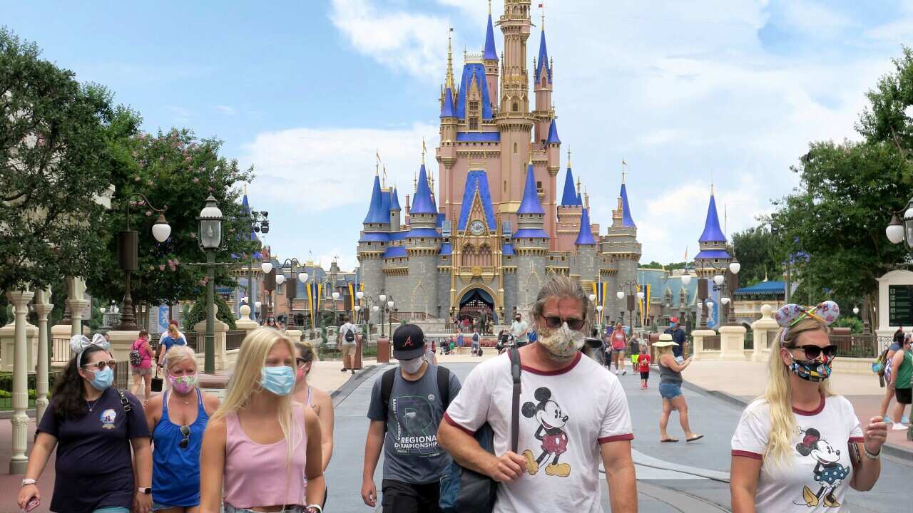 Guests wear masks at the re-opening of Walt Disney World in Lake Buena Vista, Florida