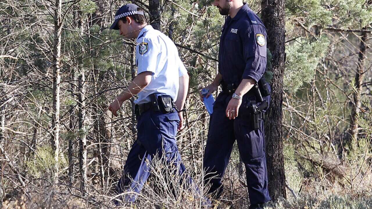Police walk into bushes in Cocoparra National Park