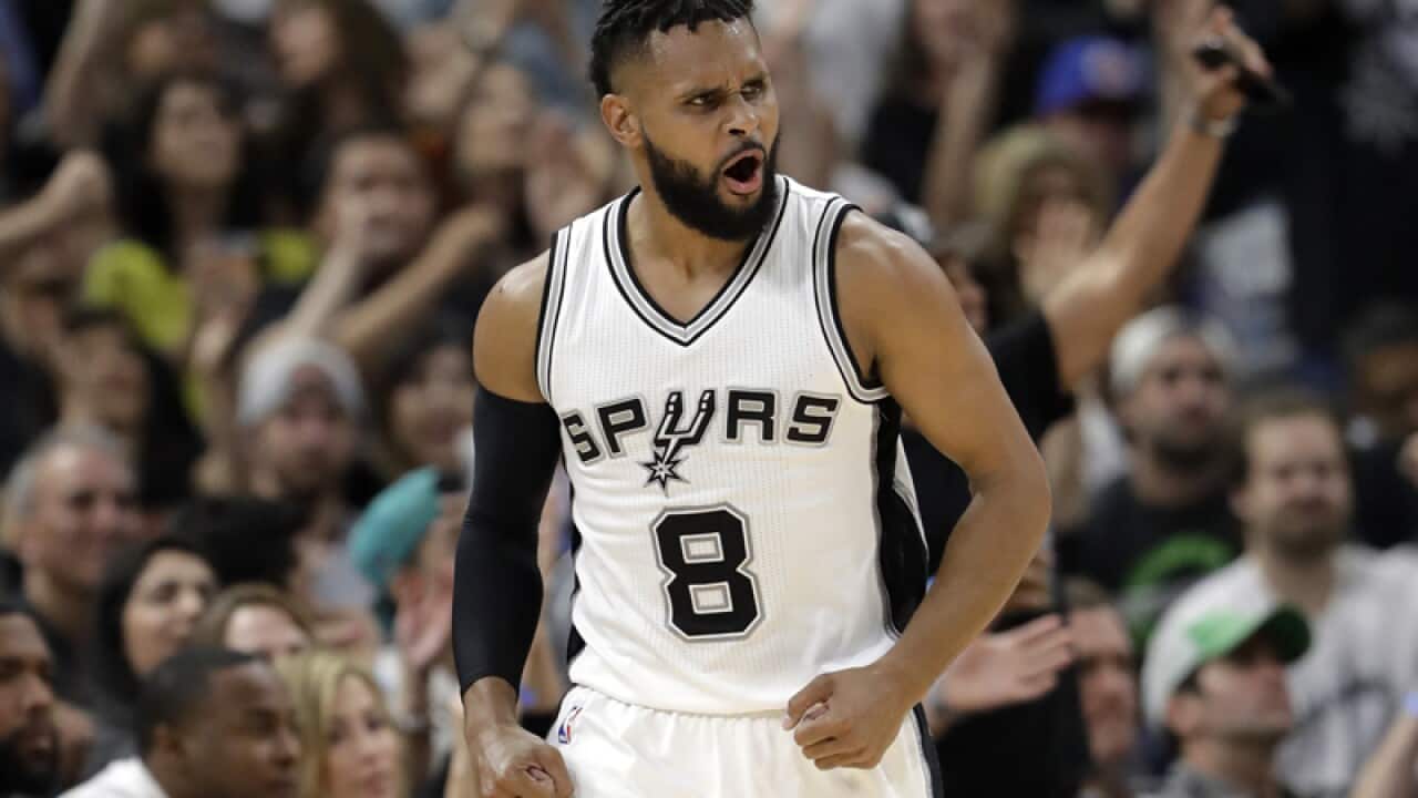 San Antonio Spurs guard Patty Mills celebrates sinking a three-point