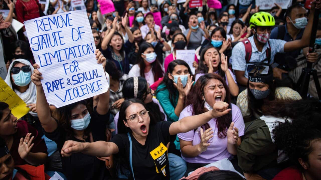 A youth holds a placard expressing her opinion during the protest.