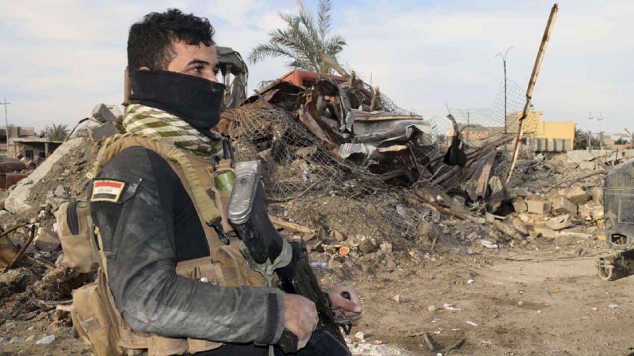 Iraqi Security forces enter the heavy damaged downtown Ramadi