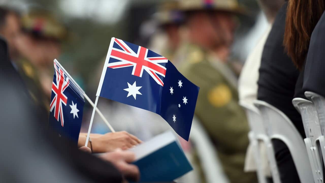Memmbers of the public hold flags at an Australia Day Citizenship Ceremony and Flag Raising event in Canberra on Tuesday, Jan. 26, 2016. (AAP Image/Mick Tsikas) NO ARCHIVING