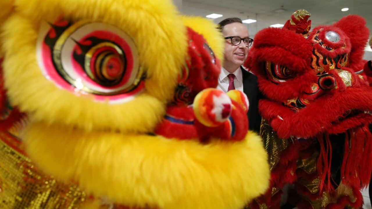 Qantas CEO Alan Joyce with two Chinese Lion dancers at Sydney airport in January 2017