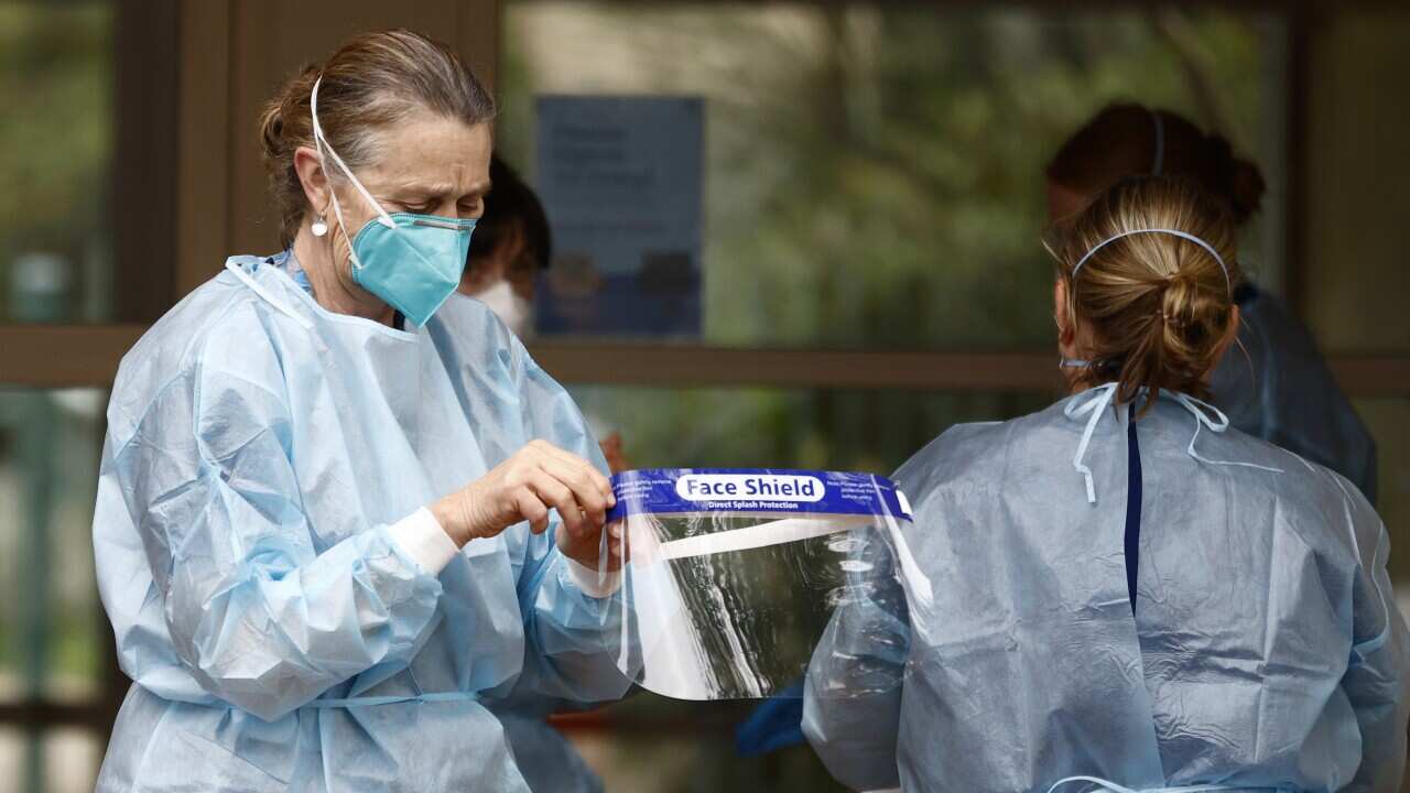 COVID-19 testing staff at the Kings Park on Southbank apartment building in Melbourne, Tuesday, 15 June, 2021.