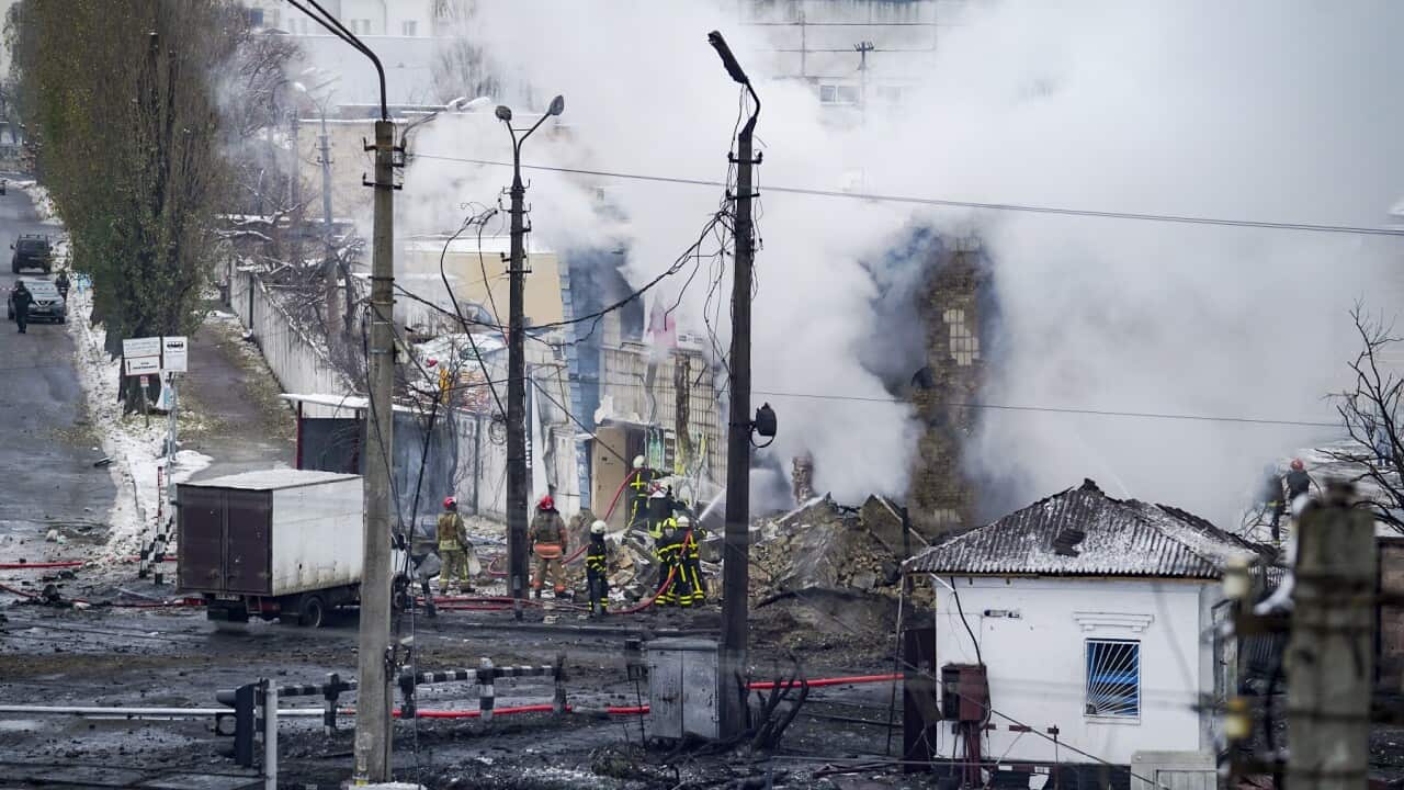 Rescuers work near a house destroyed by rocket fire in Kyiv
