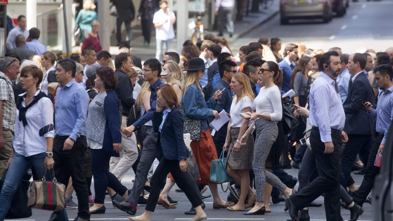 View of rushing pedestrians crossing street