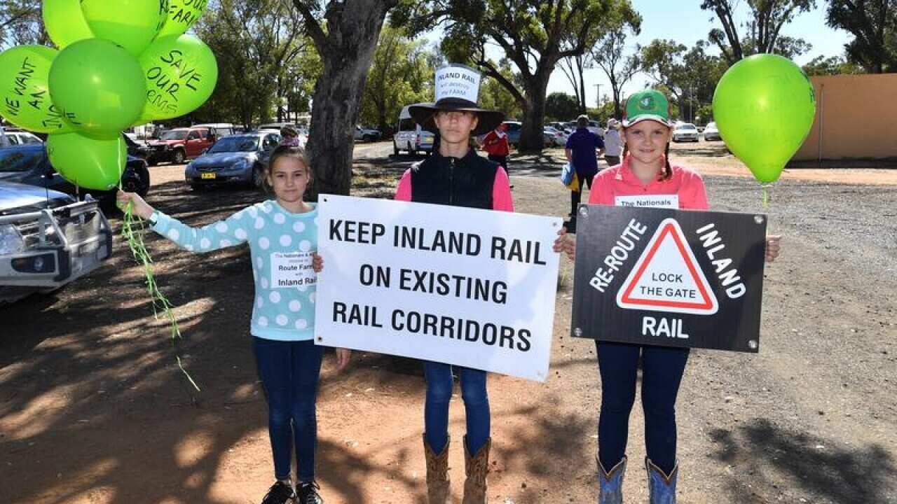 Three young girls protesting the inland rail at the Gilgandra Show.