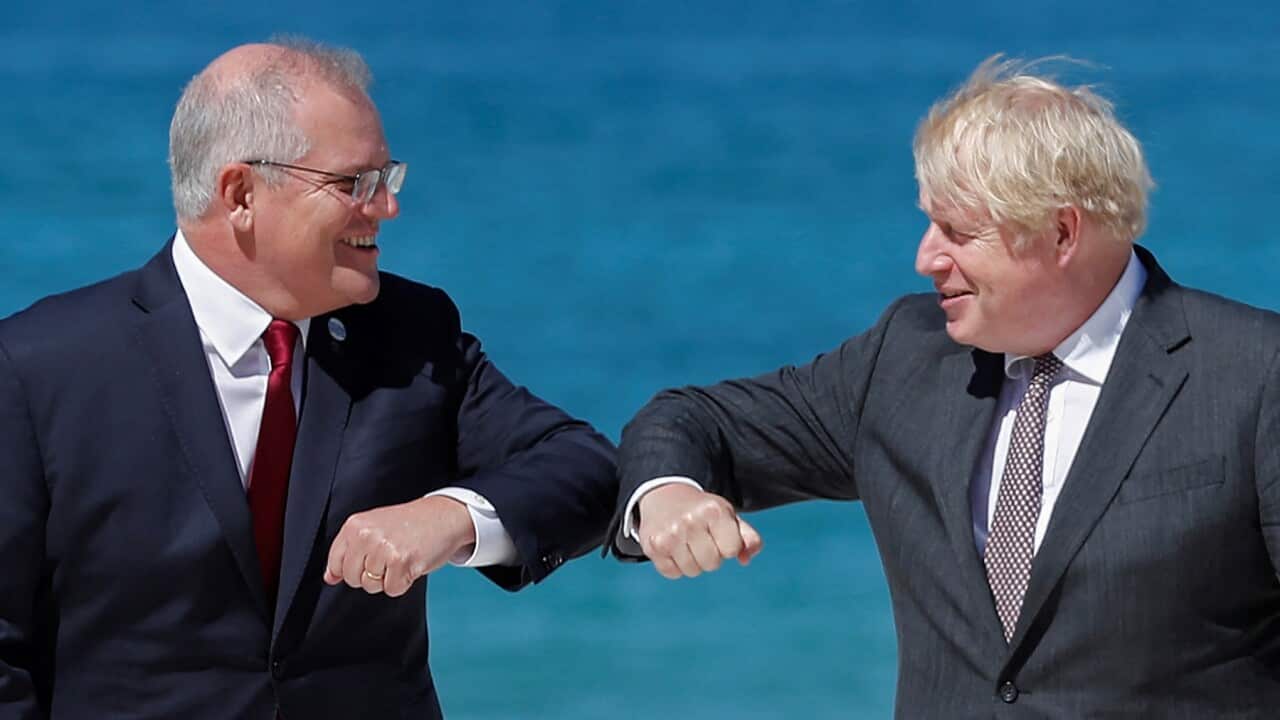 Britain's Prime Minister Boris Johnson (R) greets Australia's Prime Minister Scott Morrison (L)