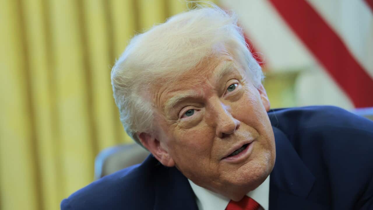President Donald Trump speaks to reporters while in the Oval Office