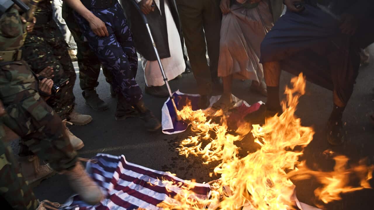 Yemeni's burn representations of American, French and Israeli flags