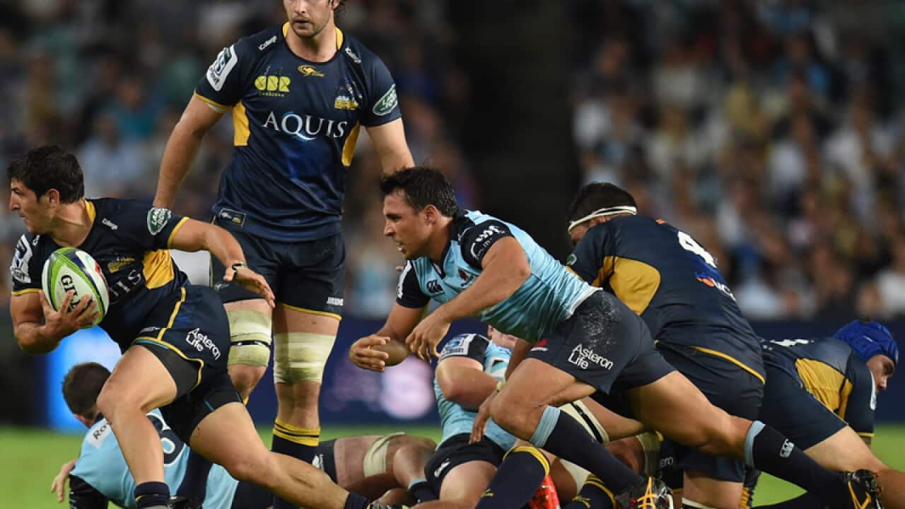 Tomas Cubelli of the Brumbies escapes a tackle