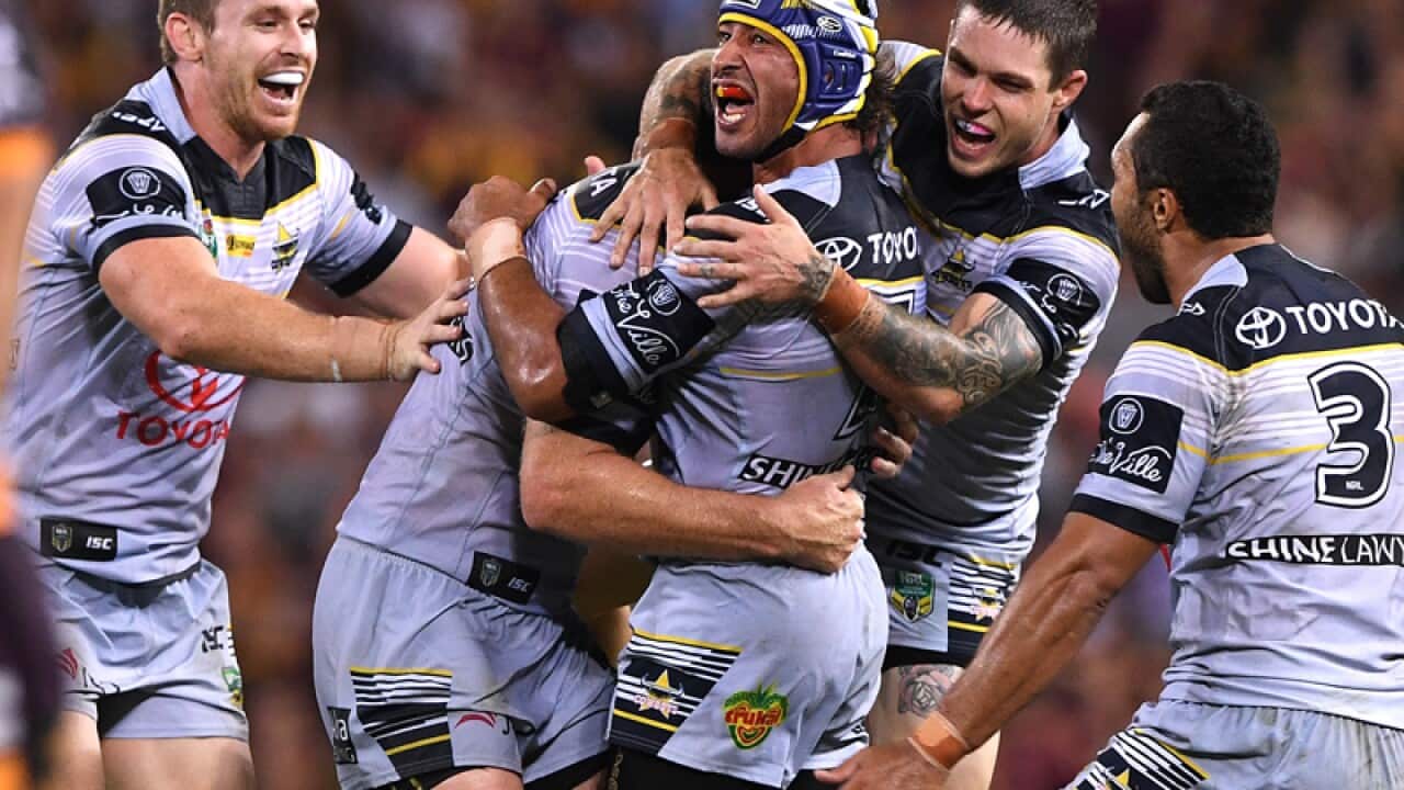 Johnathan Thurston (C) celebrates after kicking a field goal