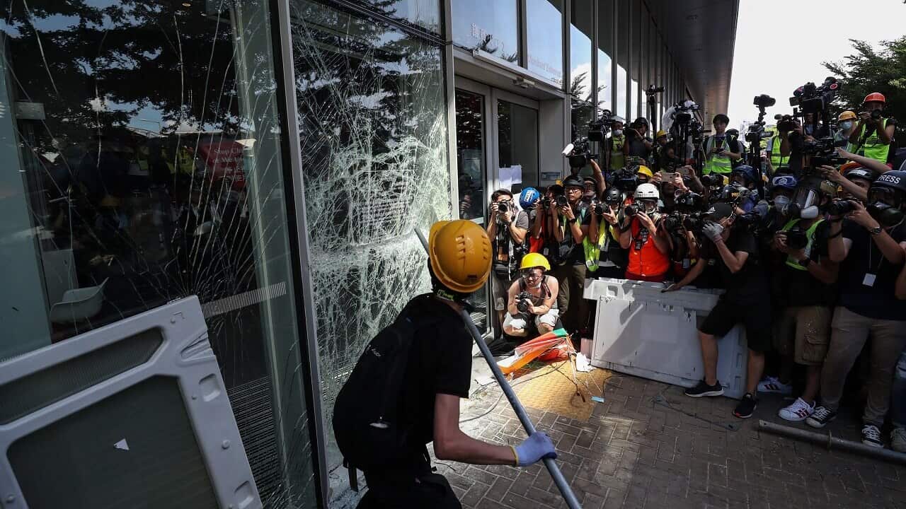 A protesters try to break a window of the Legislative Council in Hong Kong.