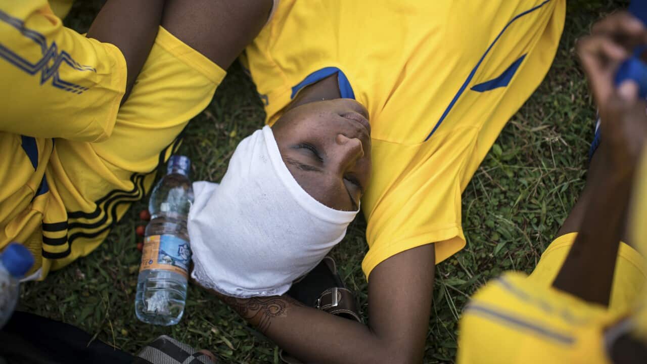 Rukia Talib Yahya, a player for the Green Queens, rests during halftime, in Jumbi, Zanzibar.