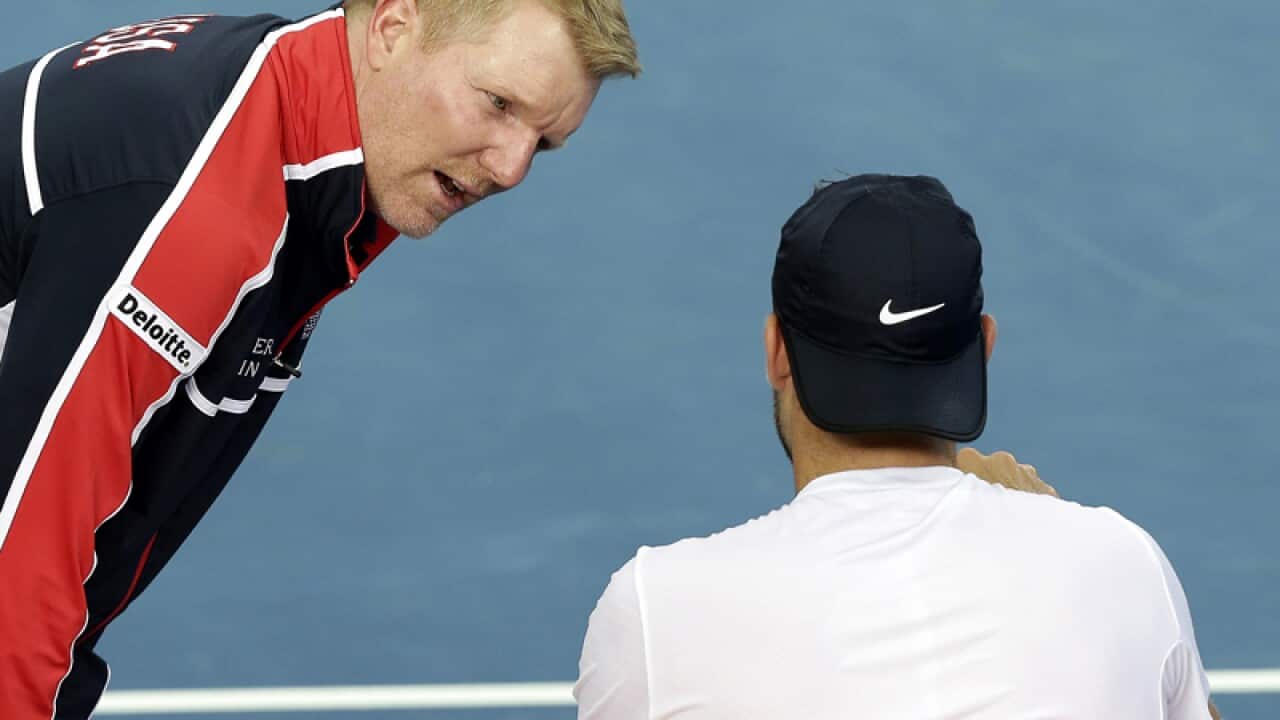 U.S. captain Jim Courier, left, talks to Jack Sock