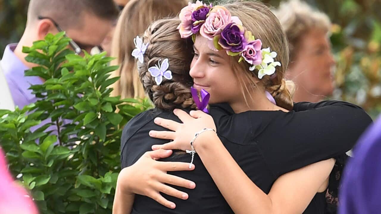 Attendee's are seen during a memorial service for Teresa Bradford