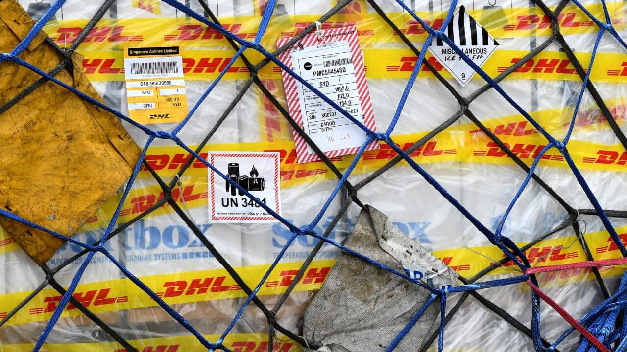 The first Australian shipment of Pfizer COVID-19 vaccines is unloaded from a Singapore Airlines plane at Sydney