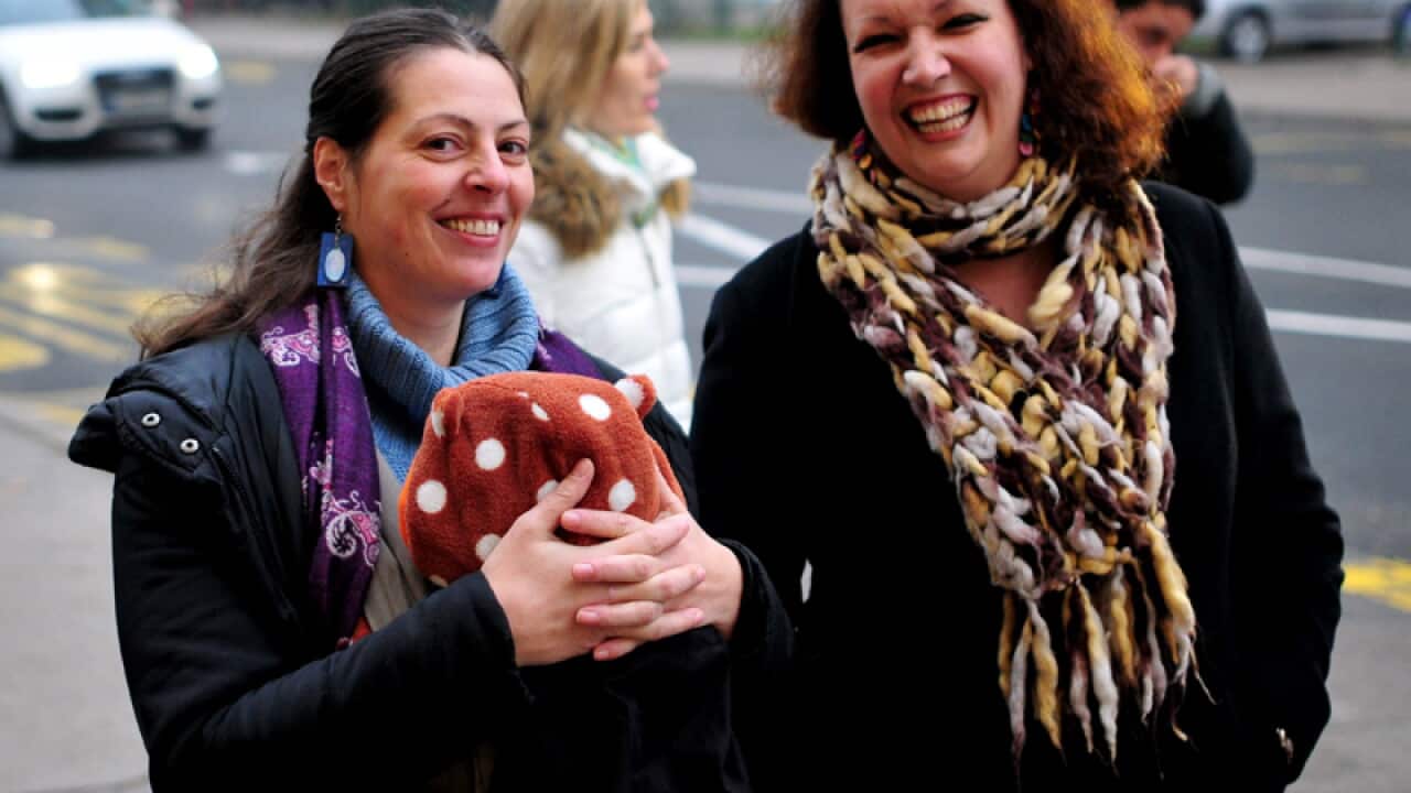 A lesbian couple walk to a polling station in Slovenia