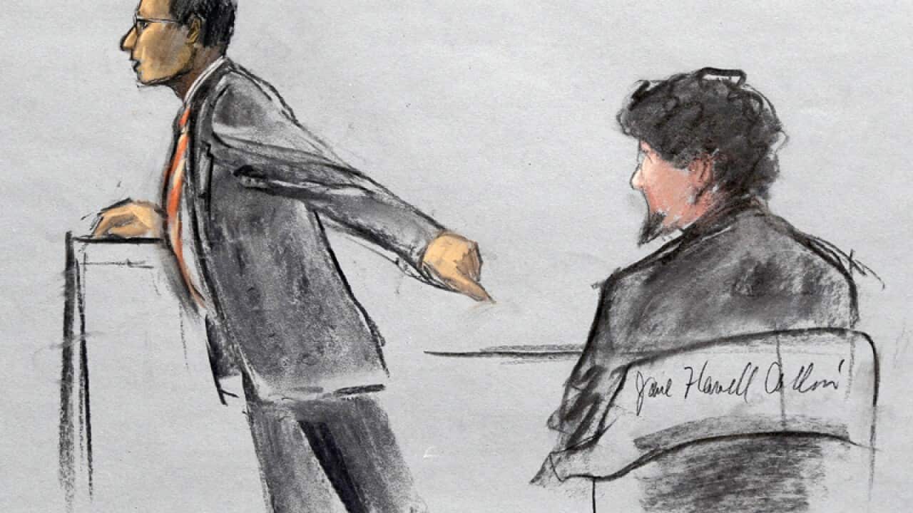 Attorney Aloke Chakravarty is depicted pointing to Dzhokhar Tsarnaev
