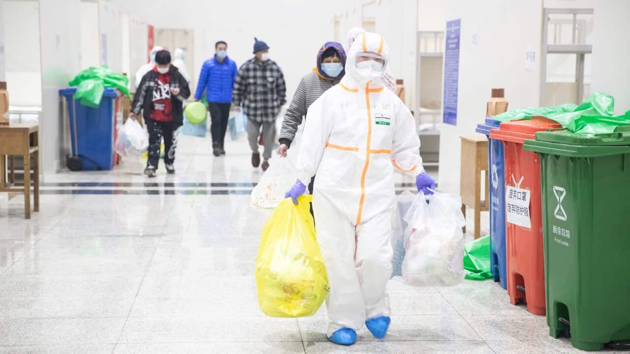 Staff members work in Wuhan International Convention and Exhibition Centre. Many are asking when a vaccine will be developed.