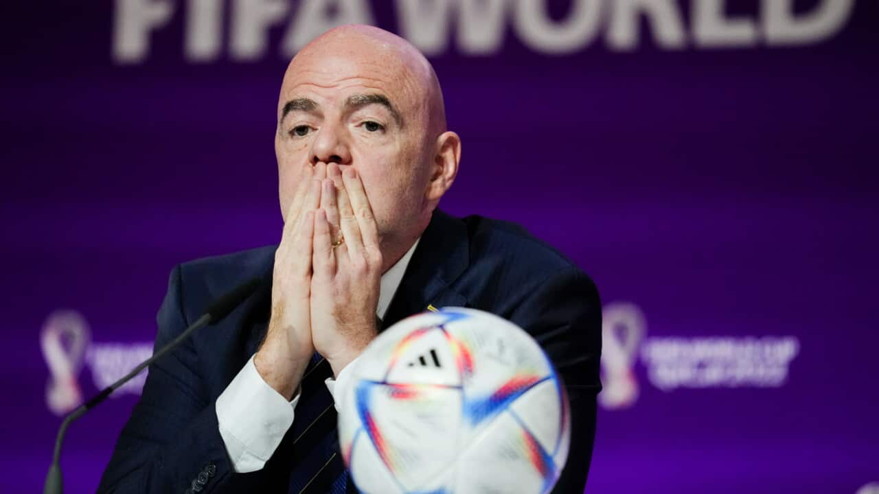 A bald man puts his head in his hands.