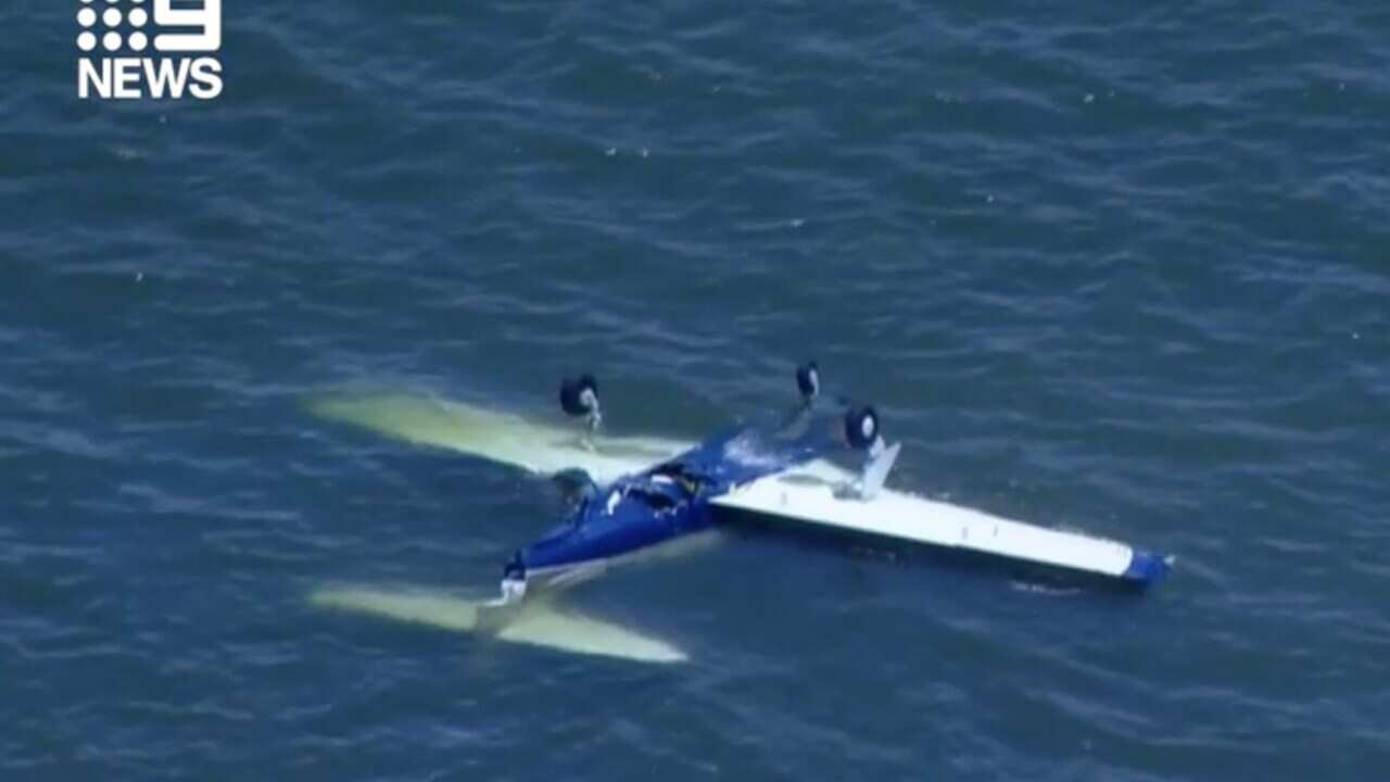 A screenshot obtained from a Nine News broadcast on Sunday, December 19, 2021, shows a light plane in water off the coast of Redcliffe, north-east of the Brisbane. Four people have died following a plane crash off the coast of Redcliffe shortly after 9am