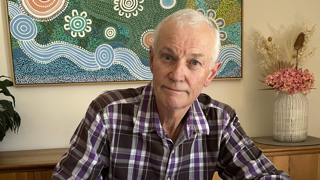 A man writes on a note pad