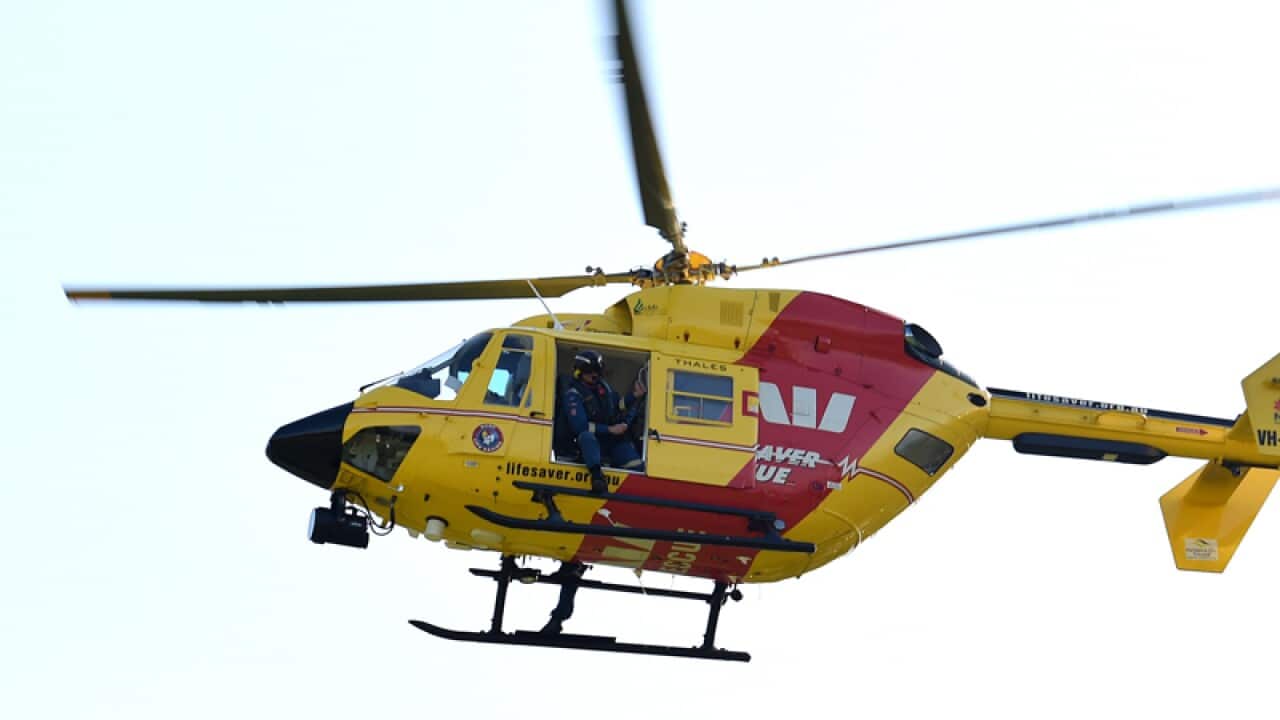 Paramedics arrive aboard a rescue helicopter